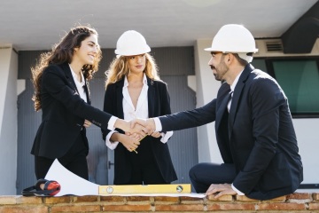 Architects Wearing Helmets Shaking Hands