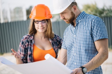 Builder Showing Blueprint to Colleague Builder Showing Blueprint to Colleague