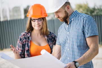 Builder Showing Blueprint to Colleague