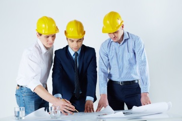 Engineers with Helmets Reviewing the Sketch Engineers with Helmets Reviewing the Sketch